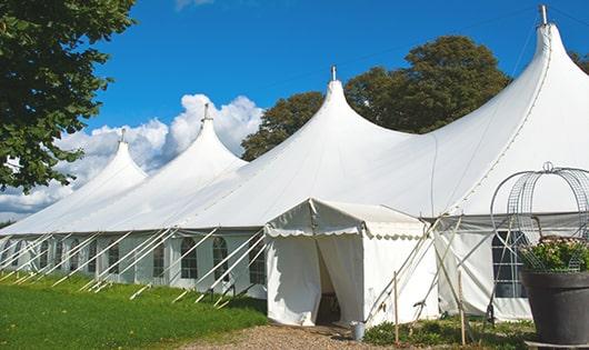 a row of portable restrooms at an outdoor festival, providing comfort and sanitation for attendees in Cape Elizabeth